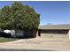 Single-story home with brick facade, desert landscaping, and mature shade tree at 730 N Karen Dr, Chandler, AZ 85224