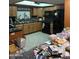 View of cluttered kitchen with wood cabinets and black appliances at 730 N Karen Dr, Chandler, AZ 85224