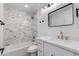 Modern bathroom featuring white marble tile, dual vanity, and bathtub with shower at 7810 E Via Camello -- # 72, Scottsdale, AZ 85258