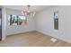 Bright dining room featuring modern chandelier, large window with a view, and light flooring at 7810 E Via Camello -- # 72, Scottsdale, AZ 85258