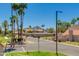Charming street view showcasing desert landscaping, palm trees, and a mountain backdrop under a clear blue sky at 7810 E Via Camello -- # 72, Scottsdale, AZ 85258