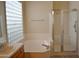 Bright bathroom with a soaking tub, a glass shower, and tile flooring at 7979 E Princess Dr # 8, Scottsdale, AZ 85255
