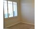 Bright bedroom featuring wood-look tile flooring and a window with white shutters for natural light at 7979 E Princess Dr # 8, Scottsdale, AZ 85255