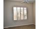 Bedroom with shuttered window and ceiling fan offers a bright, airy ambiance at 7979 E Princess Dr # 8, Scottsdale, AZ 85255