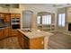 Open kitchen featuring granite countertops, an island, and built-in double ovens at 7979 E Princess Dr # 8, Scottsdale, AZ 85255