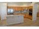 Well-equipped kitchen with stainless steel appliances, a central island, and wooden cabinets at 7979 E Princess Dr # 8, Scottsdale, AZ 85255