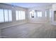 Bright living room with wood-look tile floors, a ceiling fan, and white shutters at 7979 E Princess Dr # 8, Scottsdale, AZ 85255
