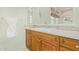 Bathroom featuring honey colored vanity with white countertop and decorative backsplash at 8298 E Tailfeather Dr, Scottsdale, AZ 85255