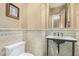 Elegant powder room with patterned tile, pedestal sink, and decorative mirror at 8298 E Tailfeather Dr, Scottsdale, AZ 85255