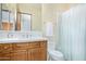 Bathroom featuring light walls, honey colored vanity and shower with curtain at 8298 E Tailfeather Dr, Scottsdale, AZ 85255