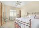 Bedroom featuring neutral walls, ceiling fan, shuttered window, and decorative vanity at 8298 E Tailfeather Dr, Scottsdale, AZ 85255