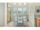Bright breakfast nook with a glass table, four chairs, large windows, and a view of the outdoors at 8298 E Tailfeather Dr, Scottsdale, AZ 85255
