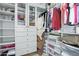 Walk-in closet with hanging rods, shelving, drawers, and storage tubs at 8298 E Tailfeather Dr, Scottsdale, AZ 85255