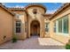Elegant arched entrance with paver walkway and desert landscaping at 8298 E Tailfeather Dr, Scottsdale, AZ 85255