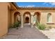 Elegant arched entrance with paver walkway and desert landscaping at 8298 E Tailfeather Dr, Scottsdale, AZ 85255