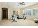 Bright exercise room with tile floors, ceiling fan, and multiple workout machines at 8298 E Tailfeather Dr, Scottsdale, AZ 85255