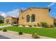 Charming stucco home features manicured lawn and desert landscaping, enhancing its curb appeal at 8298 E Tailfeather Dr, Scottsdale, AZ 85255