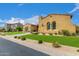 Charming stucco home features manicured lawn and desert landscaping, enhancing its curb appeal at 8298 E Tailfeather Dr, Scottsdale, AZ 85255