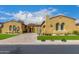 Stucco home with tile roof, beautiful archways, desert landscaping, and a well-maintained front lawn at 8298 E Tailfeather Dr, Scottsdale, AZ 85255