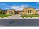 Stucco home with tile roof, beautiful archways, desert landscaping, and a well-maintained front lawn at 8298 E Tailfeather Dr, Scottsdale, AZ 85255