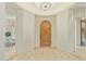 Bright entryway featuring tile flooring, arched doorways, and a classic wooden front door at 8298 E Tailfeather Dr, Scottsdale, AZ 85255