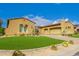 Charming single-story home with stucco and tile roof, complimented by desert landscaping and manicured lawn at 8298 E Tailfeather Dr, Scottsdale, AZ 85255