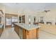 Open kitchen layout showcasing the island and stainless steel appliances connected to living room at 8298 E Tailfeather Dr, Scottsdale, AZ 85255