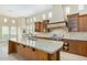 Bright, spacious kitchen with granite counters, wood cabinets, and stainless steel appliances at 8298 E Tailfeather Dr, Scottsdale, AZ 85255