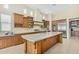 Bright kitchen featuring wood cabinets, granite counters, and stainless steel appliances at 8298 E Tailfeather Dr, Scottsdale, AZ 85255