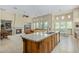 Open concept kitchen with island, seamlessly connected to the living room and fireplace at 8298 E Tailfeather Dr, Scottsdale, AZ 85255