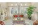 Elegant living room featuring ornate furniture, a chessboard table, and large windows with sheer curtains at 8298 E Tailfeather Dr, Scottsdale, AZ 85255