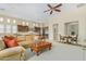 Large living room showcasing an open layout with a comfortable sofa, a kitchen and a connected sitting area at 8298 E Tailfeather Dr, Scottsdale, AZ 85255