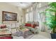 Elegant living room showcasing ornate furniture, chessboard table, art and a lush potted palm at 8298 E Tailfeather Dr, Scottsdale, AZ 85255