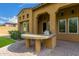 Outdoor kitchen with a BBQ on a brick patio located on the property's exterior at 8298 E Tailfeather Dr, Scottsdale, AZ 85255
