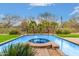 Desert oasis featuring sparkling pool, integrated spa, and verdant desert landscaping at 8298 E Tailfeather Dr, Scottsdale, AZ 85255