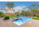 Inviting swimming pool and spa with brick surround and manicured landscaping at 8298 E Tailfeather Dr, Scottsdale, AZ 85255