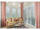 Cozy sitting area features custom draperies, white shutters, and decorative throw pillows at 8298 E Tailfeather Dr, Scottsdale, AZ 85255