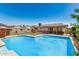 Expansive backyard oasis with a sparkling pool, covered patio, and ample space for outdoor fun at 844 E Ruth Ave, Phoenix, AZ 85020