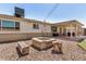 Charming backyard featuring a cozy fire pit area, a covered patio, and a well-maintained lawn at 844 E Ruth Ave, Phoenix, AZ 85020