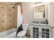 Well-lit bathroom with modern fixtures, a tiled shower/tub combo, and stylish vanity at 844 E Ruth Ave, Phoenix, AZ 85020