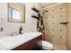 This bathroom features a stylish sink and mirror, with a tiled shower featuring eye-catching floral shower curtain at 844 E Ruth Ave, Phoenix, AZ 85020