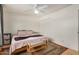 Bedroom with neutral colored walls, ceiling fan, hardwood floors, bench, and an area rug at 844 E Ruth Ave, Phoenix, AZ 85020