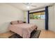 Cozy bedroom with a ceiling fan, natural light, and neutral toned walls and a decorative area rug at 844 E Ruth Ave, Phoenix, AZ 85020