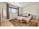 Bedroom featuring neutral colored walls, ceiling fan, hardwood floors, and a bench at the foot of the bed at 844 E Ruth Ave, Phoenix, AZ 85020