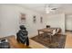 Bright dining room featuring hardwood floors, a ceiling fan, a wooden table, and matching neutral abstract art at 844 E Ruth Ave, Phoenix, AZ 85020