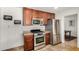 Kitchen featuring stainless steel appliances, wooden cabinets, granite countertops, and tile floors at 844 E Ruth Ave, Phoenix, AZ 85020
