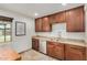 Bright kitchen featuring wood cabinets, stainless steel appliances, granite countertops, tile floors, and a sink at 844 E Ruth Ave, Phoenix, AZ 85020