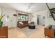 Bright living room featuring hardwood floors, updated fan, and comfortable seating at 844 E Ruth Ave, Phoenix, AZ 85020