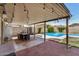Inviting covered patio with outdoor dining area and string lights overlooking the sparkling pool at 844 E Ruth Ave, Phoenix, AZ 85020