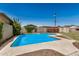 Sunny backyard featuring a sparkling pool with clear blue water and landscaped surroundings at 844 E Ruth Ave, Phoenix, AZ 85020